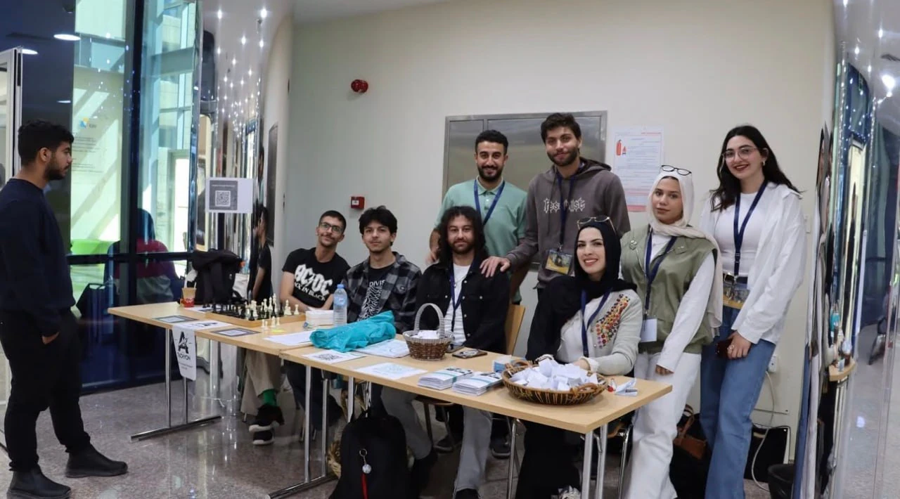 Club participants gathered beside an information table